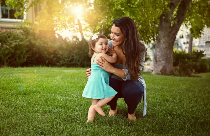 mom and daughter playing in front yard